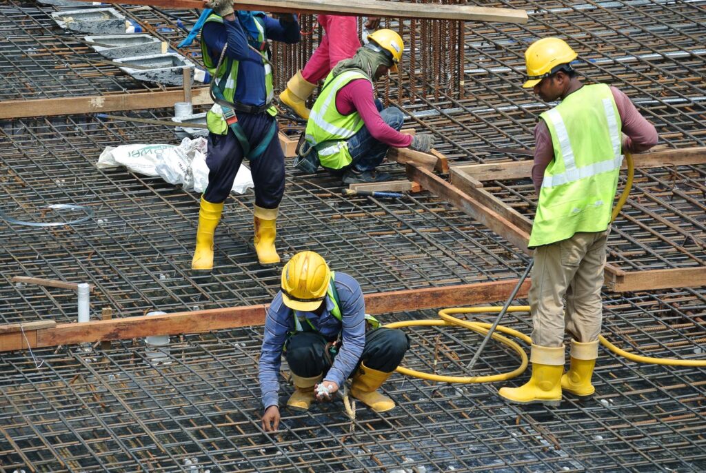 MALACCA, MALAYSIA -MAY 27, 2016: Construction workers fabricating steel reinforcement bar at the construction site in Malacca, Malaysia. The reinforcement bar was ties together using tiny wire.
